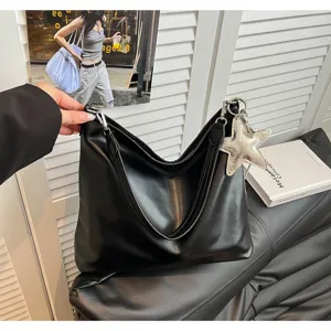Chic black leather tote bag for women, stylish shoulder bag with star charm for daily commute.