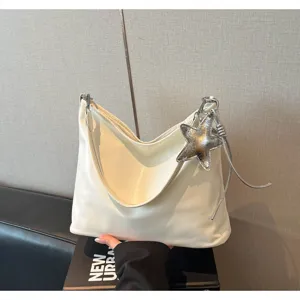 White PU leather tote bag with silver star pendant, stylish shoulder bag for women commuting.