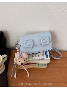 Chic light blue womens crossbody bag with cute bear pendant and vintage double buckles for daily style