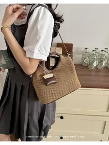Detailed view of the woven bucket bag with leather trim and mini pouch in lifestyle setting.