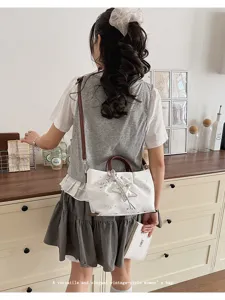 Trendy women's contrast color tote shoulder bag with star pattern and brown handle, chic.