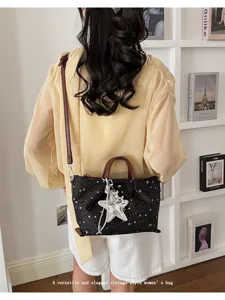 Vintage star print canvas women shoulder bag with top handle and stylish silver star charm detail.