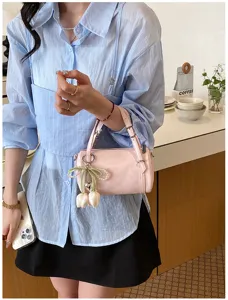 Minimalist pink pillow bag with cute tulip charm, stylish crossbody handbag for women daily wear.
