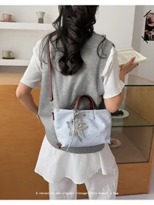 Vintage style star pattern tote bag with shoulder strap and chic pendant charm for women.