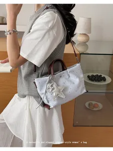 Stylish star print women's tote bag with brown handles and chic charm for daily summer wear.