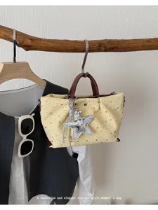 Women vintage style star print tote shoulder bag detail view with stylish star charm pendant