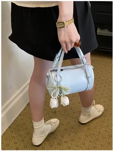 Chic light blue cylindrical pillow shoulder bag with elegant pearl tulip charm for women.