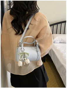 Chic light blue leather shoulder barrel bag with cute pearl tulip charm for women.