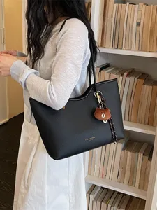 Black leather tote bag for women, large capacity shoulder bag with cute bear pendant and strap.
