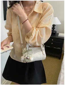 Stylish minimalist white pillow shoulder bag for women, chic crossbody bag with pearl charms.