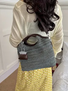Womens woven shoulder bag stylish casual commute handbag with chic leather handle and charm.