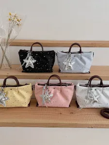 Women's trendy star print tote bag with shoulder strap and silver star pendant, main view display