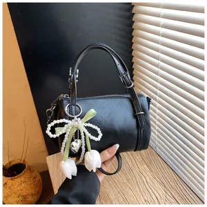 Black chic pillow bag with pearl tulip pendant, stylish top handle handbag for women daily wear.