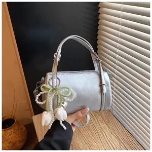 Silver pillow shoulder bag with pearl tulip pendant, stylish crossbody bag for women spring.