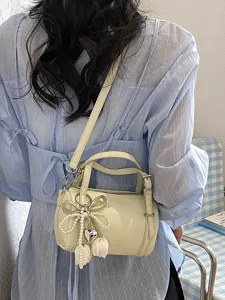 Chic light yellow cylindrical pillow shoulder bag with cute pearl bow and tulip charm.