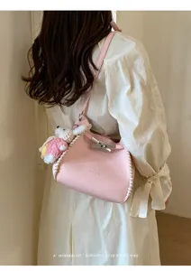 Pink leather shoulder bag with braided edge and chic turn lock design for women.