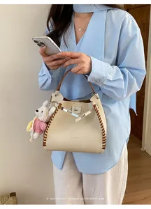 Chic contrast-stitch shoulder bag for women, premium textured commuter crossbody handbag.