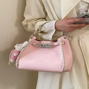 Pink litchi texture woven handbag for women, stylish niche design commuter crossbody bag.