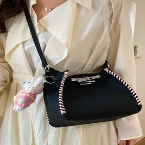 Black leather crossbody bag with pink woven edges and metal lock for women daily commuting.
