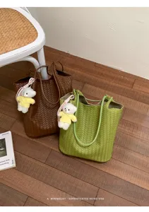 Detailed view of stylish Korean design woven bucket tote shoulder bag with cute bear charm.
