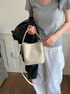 Chic beige woven bucket bag for women, stylish leather shoulder and crossbody handbag.