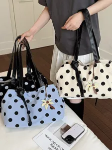 Chic polka dot canvas shoulder bag with leather straps and cute palm charm for summer.