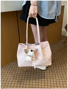 Pink woven tote bag for women, large capacity stylish shoulder handbag with cute plush pendant charm.