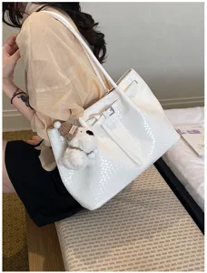 Detailed view of women's woven texture tote bag featuring large capacity and stylish design.