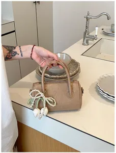 Summer chic small Boston handbag for women, trendy PU leather pillow purse with pearl bow.