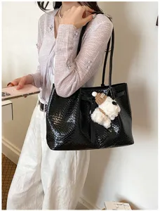 Black woven tote bag for women, large capacity stylish shoulder bag with cute dog pendant.