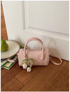 Pink cylindrical pillow bag for women, chic handbag with pearl tulip pendant for summer.