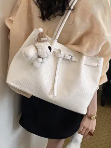 Chic woven tote bag for women, large capacity shoulder handbag with dog pendant.