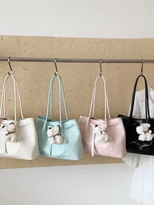 Stylish woven tote bag for women, large capacity shoulder bag with cute puppy charm for commute.