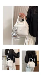 Chic white leather handbag with star charm, versatile shoulder and crossbody bag for women.