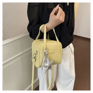 Chic yellow leather handbag with silver star pendant, versatile casual shoulder crossbody bag.