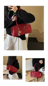 Chic red shoulder bag with metal buckle and charm, stylish versatile handbag for daily commute.