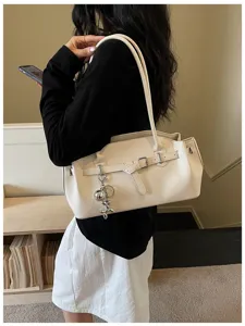 Chic beige textured leather shoulder underarm bag detail showcasing elegant metal hardware.