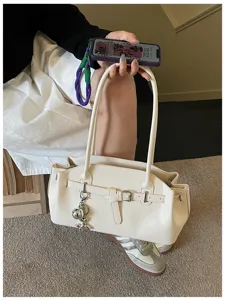 Fashionable white shoulder underarm bag for women, high-end textured commuting handbag.