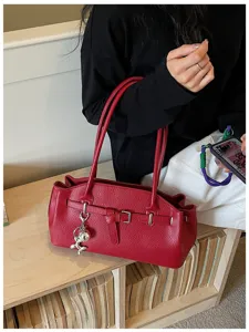 Stylish red leather shoulder bag with buckle detail and cute balloon dog charm for women!