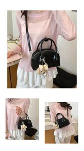 Women fashion black shoulder bag casual crossbody handbag with cute bear pendant for daily wear.