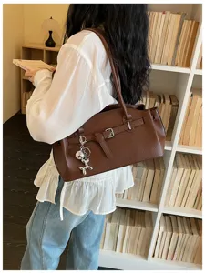 Chic brown leather shoulder bag for women, stylish underarm tote for daily commute.
