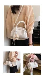 Stylish white handbag featuring cute plush bear pendant, casual women crossbody bag.