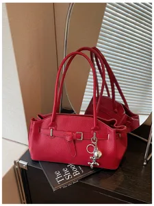 Chic red leather shoulder bag for women, stylish underarm handbag for daily commute.