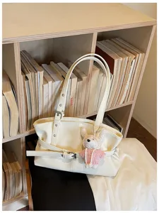 White PU leather shoulder tote bag featuring stylish belt decoration and cute bunny pendant.