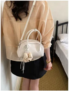 Stylish white PU leather handbag with cute bear charm, casual fashion shoulder bag for women.
