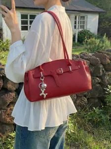 Red leather shoulder bag for women, stylish underarm tote bag with belt and cute dog charm.