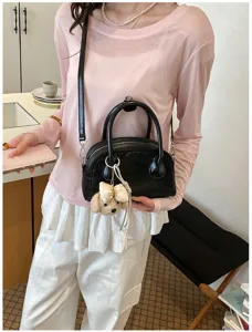 Stylish black shoulder crossbody baguette bag for women with cute puppy bow charm daily use.