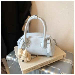 Elegant light blue shoulder handbag with cute bow plush pendant, stylish casual daily design.