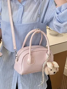 Stylish pink handbag for women, trendy PU leather top handle crossbody bag with cute dog pendant.