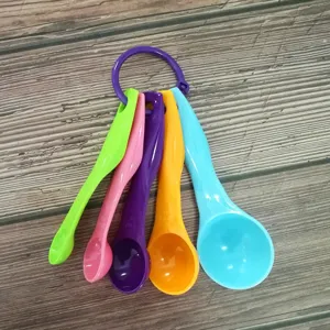 Colorful plastic measuring spoons detail view showing scale marks and connection ring